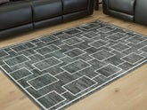 Bay Furniture Gallery - Ashley Furniture - Elderland Rug - Washable 5' x 7' Area Rug / Black/Gray - R407402